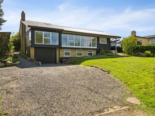 a detached house with a garage and a driveway at Holiday Home Sölvy - 300m from the sea by Interhome in Børkop