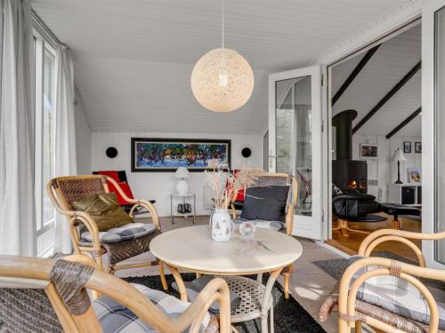 a living room with a table and chairs at Holiday Home Magnus - 250m to the fjord by Interhome in Esbjerg