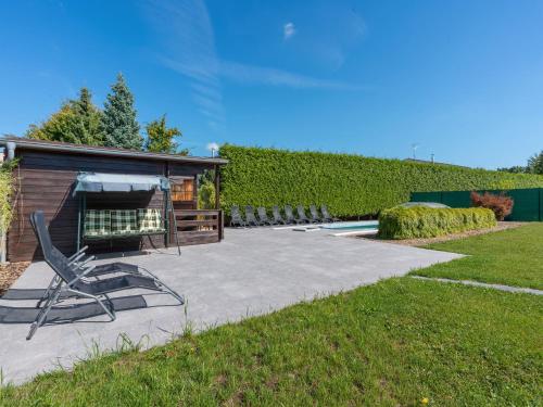 a patio with a chair next to a building at Villa Pool & Garden Villa by Interhome in Prague