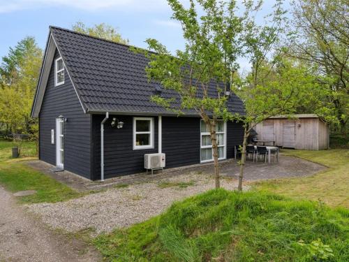 a black house with a yard at Holiday Home Øgot by Interhome in Give
