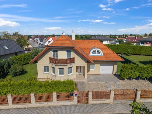 a large house with an orange roof at Villa Pool & Garden Villa by Interhome in Prague