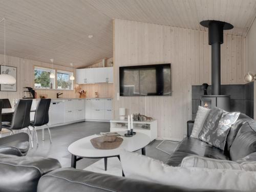 a living room with a couch and a table at Holiday Home Onni - 2-3km from the sea by Interhome in Saltum