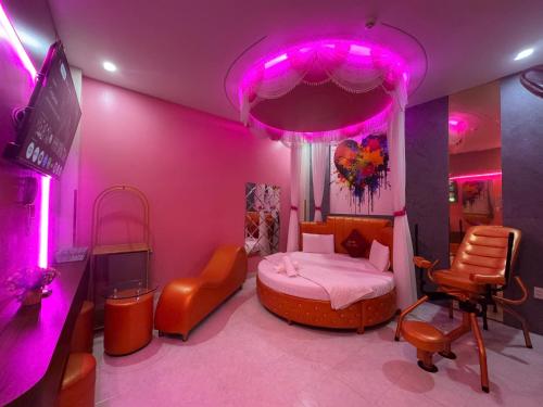 a bedroom with a bed with pink lights on it at Khách Sạn Thu Hà in Ho Chi Minh City