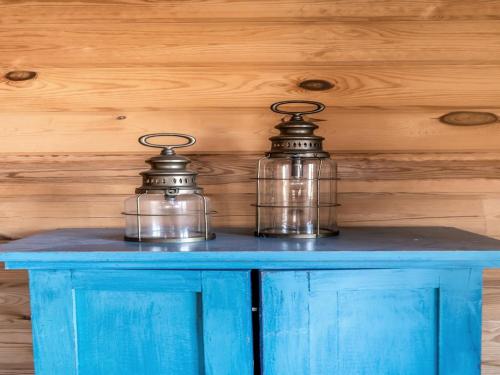 two glass jars sitting on top of a blue table at Holiday Home Franka - from the sea by Interhome in Melby