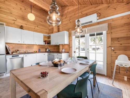 a kitchen with a wooden table and chairs at Holiday Home Franka - from the sea by Interhome in Melby