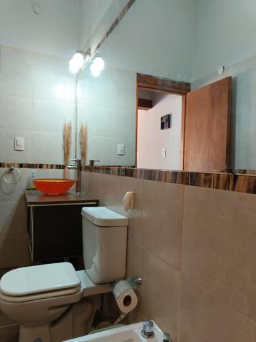a bathroom with a white toilet and a sink at Hospedaje Cabañas Costa Tilcara in Tilcara