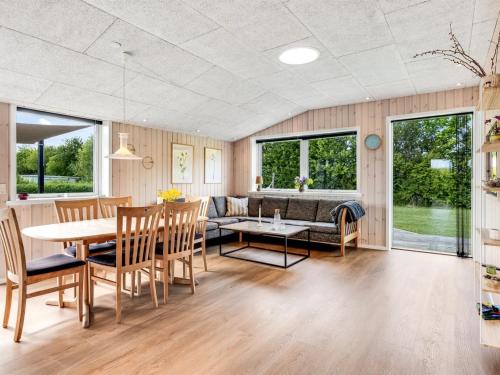 a living room with a table and a couch at Holiday Home Helmtrud - 700m from the sea by Interhome in Neder Lysabild