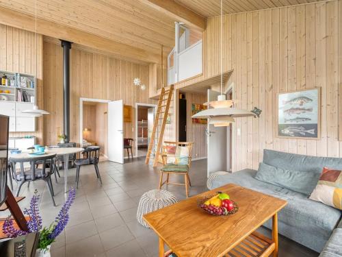 a living room with a couch and a table at Holiday Home Felicita - from the sea by Interhome in Ulfborg