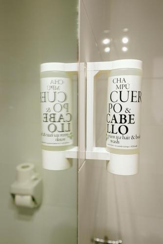 a bathroom with two white cups in a mirror at Hospedium Hotel Continental in Mojácar