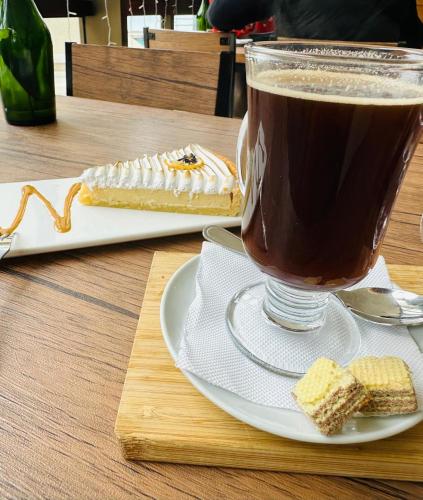 a cup of coffee and a piece of cake on a table at San Alfonso del Mar la mejor vista de Algarrobo in Algarrobo