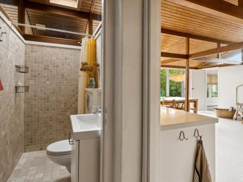 a bathroom with a toilet and a sink at Holiday Home Lauri - 2-3km from the sea by Interhome in Vejby
