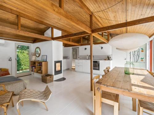 a kitchen and dining room with a wooden ceiling at Holiday Home Lauri - 2-3km from the sea by Interhome in Vejby