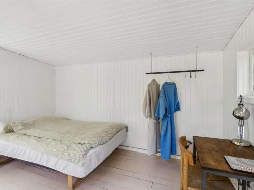 a bedroom with a bed and a desk and a table at Holiday Home Lauri - 2-3km from the sea by Interhome in Vejby