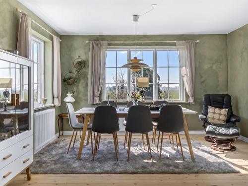 a dining room with a table and chairs at Holiday Home Freja - 12km from the sea by Interhome in Bredebro