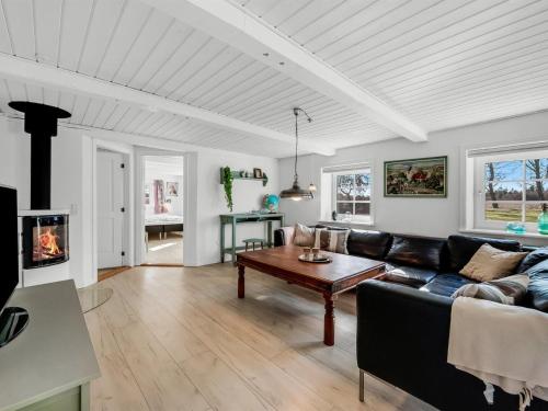 a living room with a couch and a table at Holiday Home Brigitte - 1-3km to the fjord by Interhome in Skjern