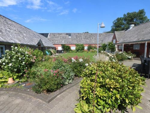 a garden of flowers in front of a building at Holiday Home Brigitte - 1-3km to the fjord by Interhome in Skjern