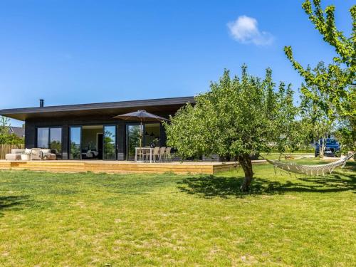a house with a hammock in the yard at Holiday Home Edvia - 200m to the fjord by Interhome in Holbæk