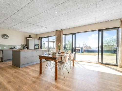 a kitchen and dining room with a table and chairs at Holiday Home Edvia - 200m to the fjord by Interhome in Holbæk