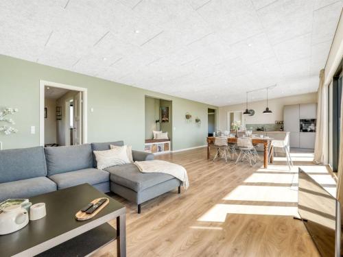a living room with a couch and a table at Holiday Home Edvia - 200m to the fjord by Interhome in Holbæk
