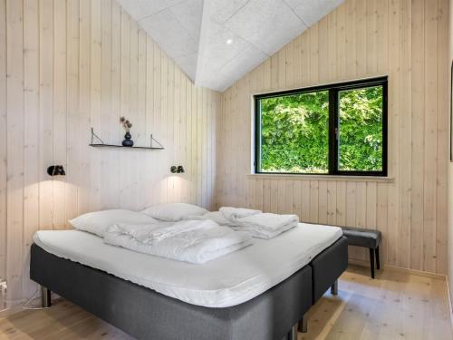 a large bed in a room with a window at Holiday Home Goesta - 250m from the sea by Interhome in Haderslev