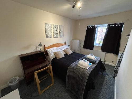 a bedroom with a bed and a piano at The Shaw House, 1 in Knutsford