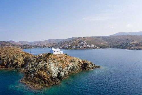an island with a white lighthouse on a body of water at Selene in Ligia