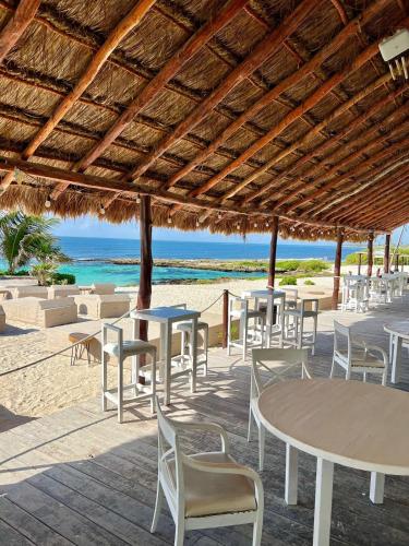 a group of tables and chairs on the beach at Beachfront Condominium in Tulum in Tulum