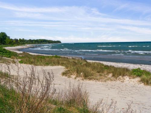 a sandy beach with the ocean in the background at Holiday Home Bodulf - 300m from the sea by Interhome in Hornbæk