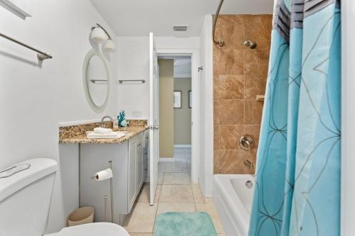 a bathroom with a shower and a toilet and a sink at Ocean72 Holmes Beach Vacation Home with Private Pool & hot tub & Walk-to-Beach Access in Holmes Beach