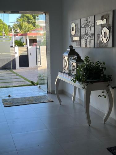 a table with a potted plant on it in a room at Happy home in La Romana