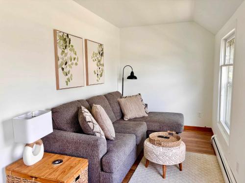 a living room with a couch and a table at Relaxing Upper Level Retreat Near Torch Lake & River in Rapid City