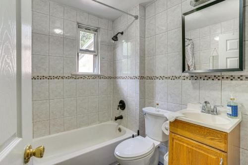 a bathroom with a tub and a toilet and a sink at Walkable Location Pet-Friendly Apartment in Lodi! in Lodi