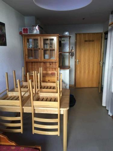 a room with a table and chairs and a refrigerator at Ski en 5 secondes! in Val Cenis