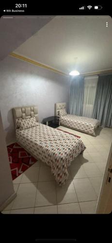 Una cama o camas en una habitación de Apatrement face ou Souk