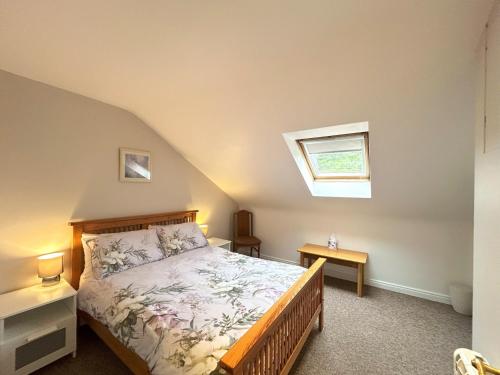 a bedroom with a bed and a window at 93 Clifden Glen in Clifden