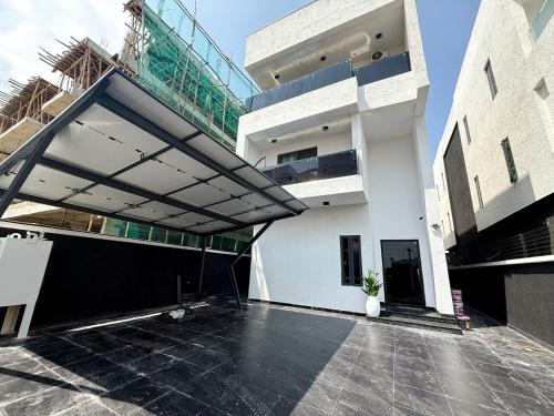 a large white building with a balcony on it at Ncomhome Luxury Villa in Lekki