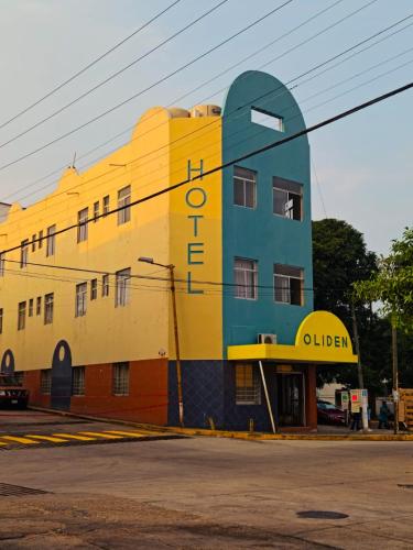 a yellow and blue building with a sign on it at HOTEL OLIDEN in Coatzacoalcos