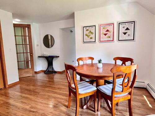 a dining room with a wooden table and chairs at Torch Lake Vista With Lake access in Rapid City