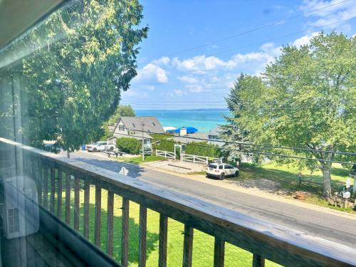 a balcony with a view of a road and the ocean at Torch Lake Vista With Lake access in Rapid City