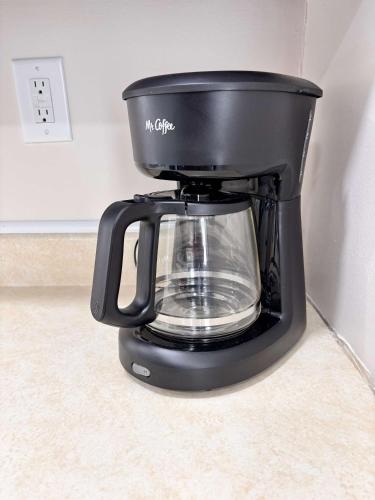 a black coffee maker sitting on a counter at Torch Lake Vista With Lake access in Rapid City