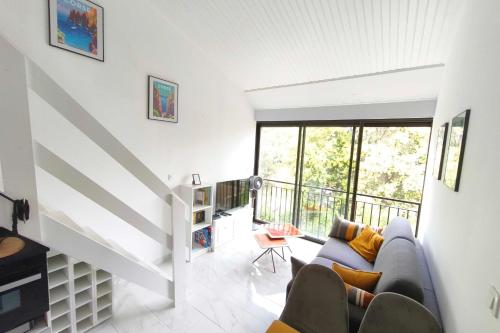 a living room with a couch and a balcony at Studio with sea view in Orcino