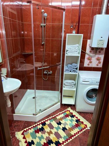 a bathroom with a shower and a toilet and a sink at Чернівці Апартаменти in Chernivtsi