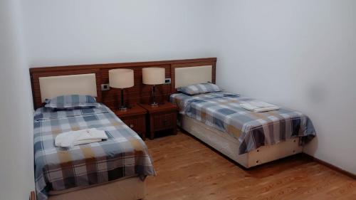 two beds sitting next to each other in a room at комфорт in Marneuli