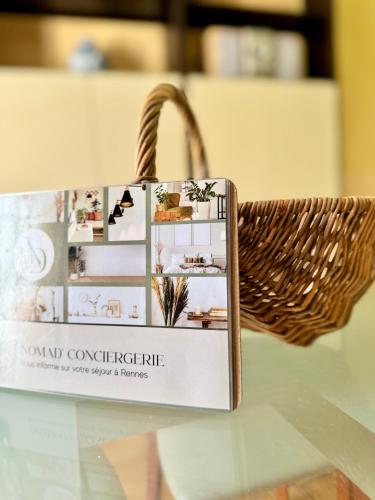 a basket with a book on top of a table at La Maison Bretonne in Chartres-de-Bretagne