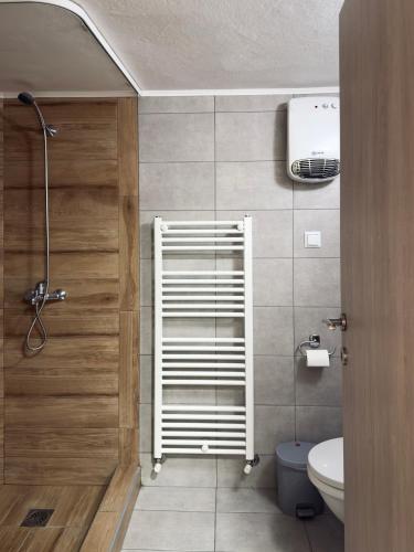 a bathroom with a toilet and a towel rack at Benoikon House With Free Private Parking in Serres