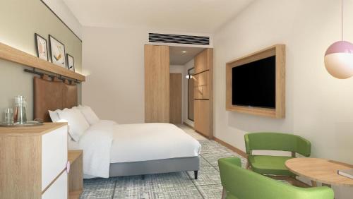 a hotel room with a bed and a desk and chair at Holiday Inn Melbourne Bourke Street Mall by IHG in Melbourne
