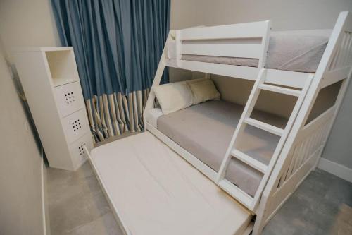 a room with two bunk beds and a ladder at Family Surf Villa with Resort Amenities at Venao in Playa Venao
