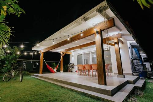 a porch of a house at night with a playground at Family Surf Villa with Resort Amenities at Venao in Playa Venao