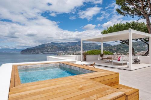 a house with a swimming pool and a gazebo at Villa Coralia Luxury Suite in Amalfi Coast, Sorrento, Italia in Sorrento