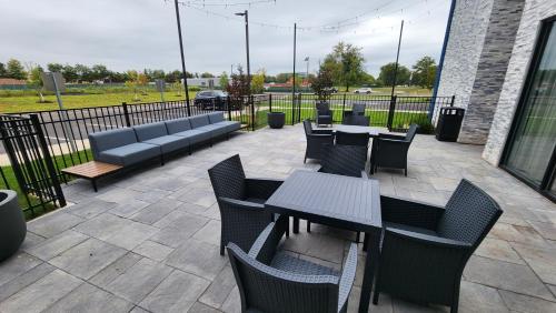 a patio with tables and chairs and a couch at Hampton Inn & Suites Somerset in Somerset